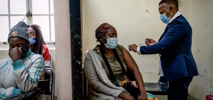 A woman is vaccinated against COVID-19 at the Hillbrow Clinic in Johannesburg, South Africa, Monday Dec. 6, 2021. South African doctors say the rapid increase in COVID-19 cases attributed to the new omicron variant is resulting in mostly mild symptoms. (AP Photo/ Shiraaz Mohamed)