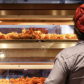 A restaurant worker fills chicken order