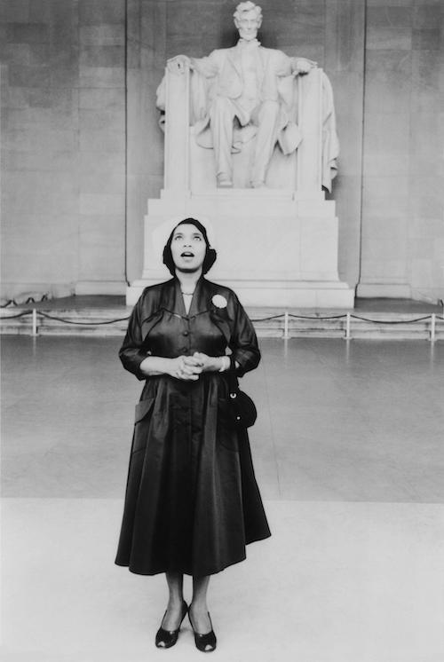 Opera singer Marian Anderson stands in front of the statue of Lincoln at the Lincoln Memorial in Washington D.C., the site of her memorable Easter Sunday concert in 1939.