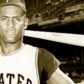 Roberto Clemente with bat resting behind head
