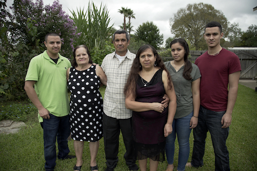 Five members of latino family pose for photo