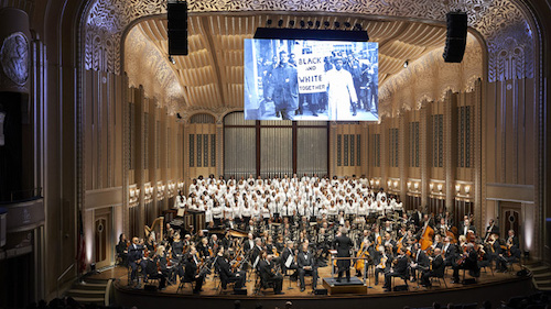 Wide shot of large orchestra and choir