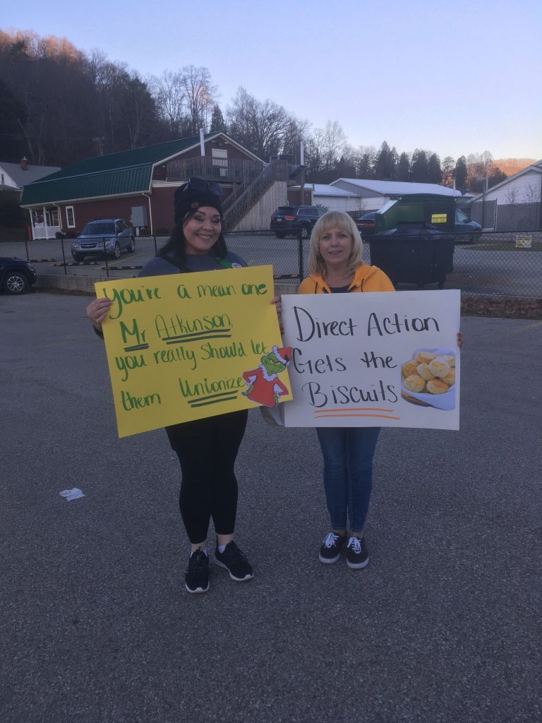 Two union members stand in solidarity with the Tudor’s Biscuit World workers in Elkview