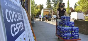 A volunteer helps set up snacks at a cooling center established to help vulnerable residents ride out the second dangerous heat wave to grip the Pacific Northwest last summer