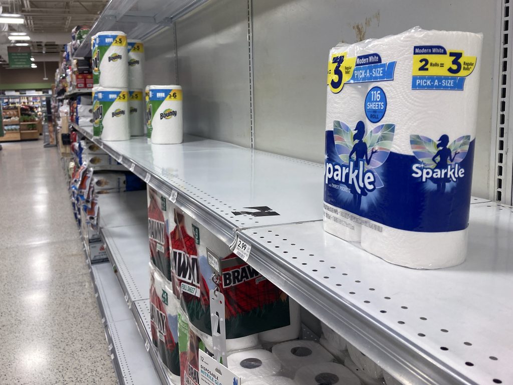 A supermarket aisle with sparse supplies