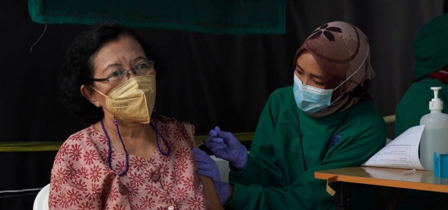 A resident receives a dose of the Pfizer COVID-19 vaccine at a health center in Jakarta, Indonesia, on Jan. 13. This week, Indonesia started a program to give booster shots to the elderly and people at risk of severe disease.