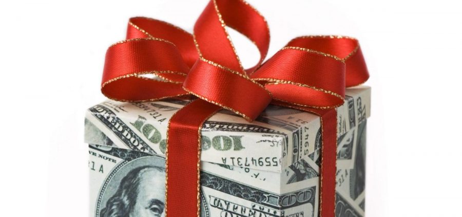 A package wrapped with money has a red ribbon tied around it