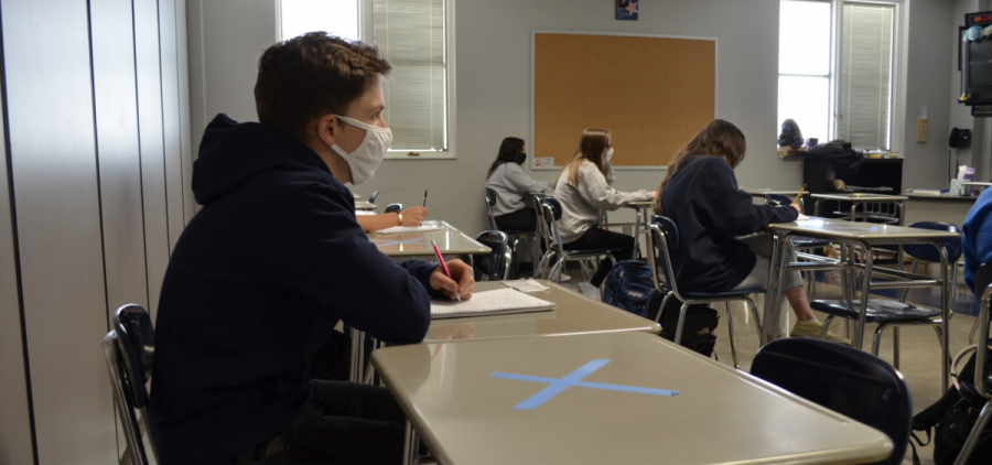 Masked students sit in a classroom at Worthington Kilbourne High School near Columbus in March 2021