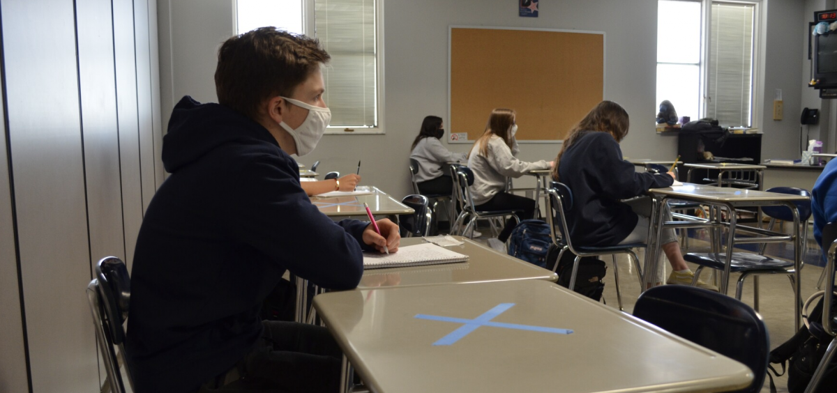 Masked students sit in a classroom at Worthington Kilbourne High School near Columbus in March 2021
