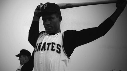 Roberto Clemente stretching with bat overhead