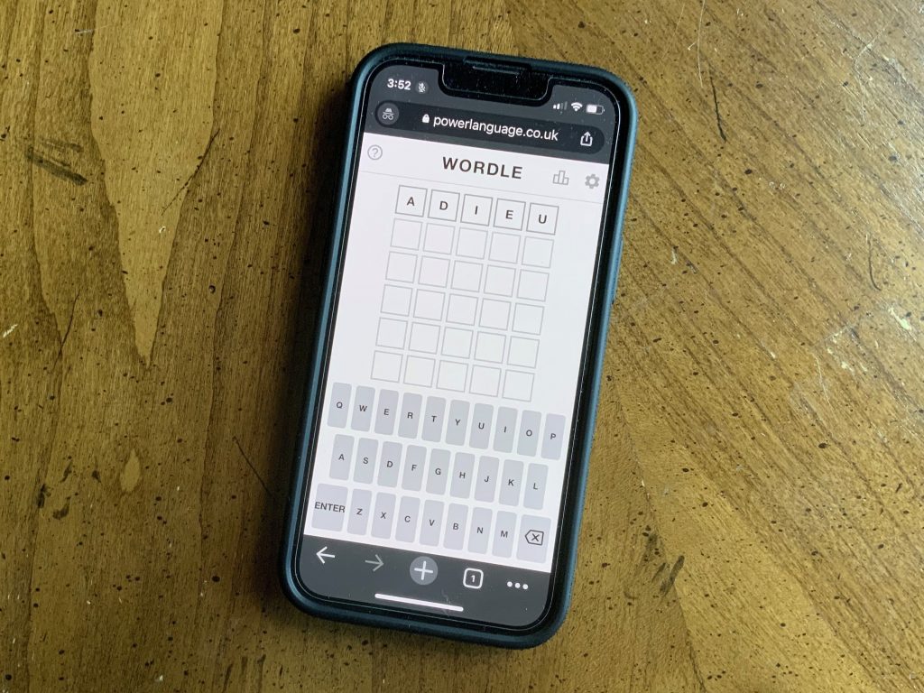 A cell phone shows a Wordle puzzle in progress
