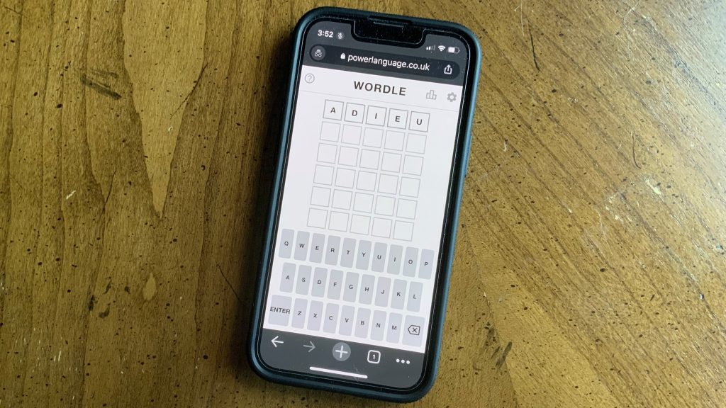 A cell phone shows a Wordle puzzle in progress