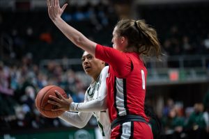 Cece Hooks, left, tries to pass around Ball State University’s Ally Becki in their basketball game against the Ohio University Bobcats