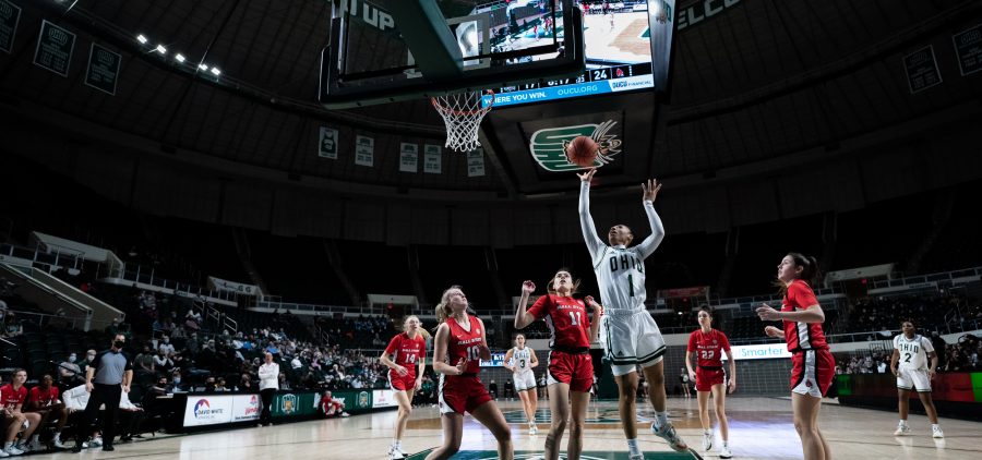 Cece Hooks, number 1, leaps into the air attempting a shot in Ohio University women’s basketball game against Ball State University, in Athens