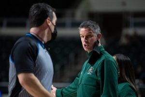 Ohio University women’s basketball coach Bob Boldon, right, discusses a call with a referee during their game against Ball State University, in Athens, Ohio, on Wednesday, Feb. 2, 2022. Ball State University went on to win 84-76. [Joseph Scheller | WOUB]