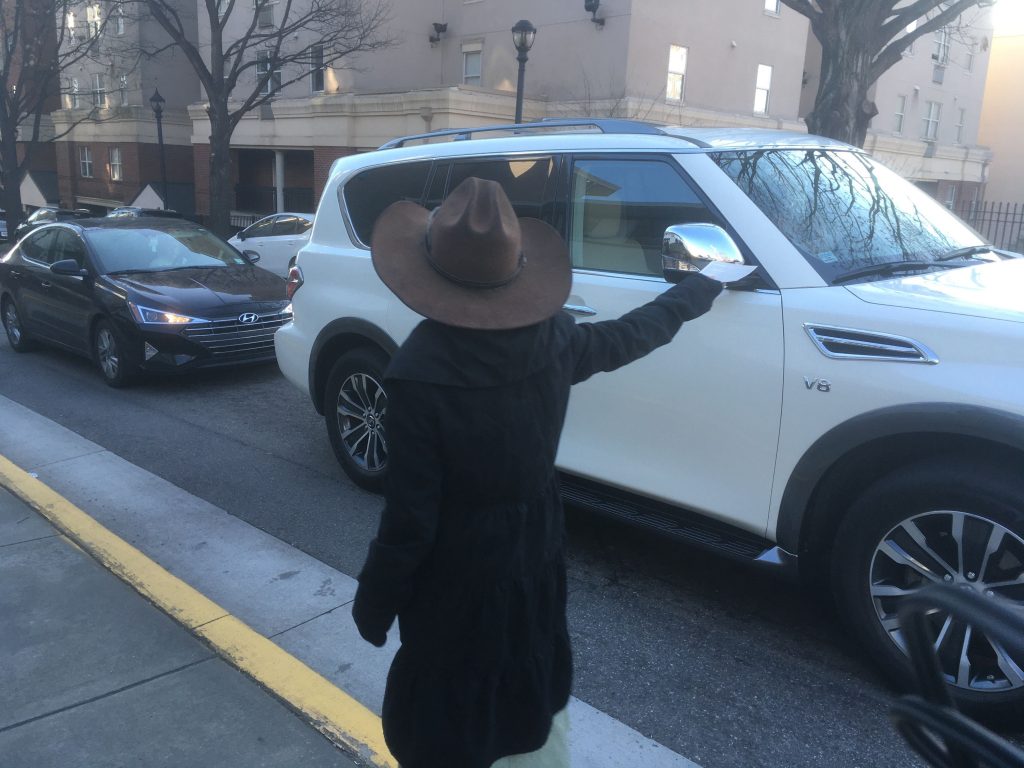 A young girl wearing a cowboy hat hands out anti-abortion flyers.