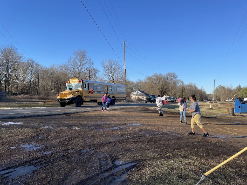 A school bus drops off kids to meet family members staying on Seavers’ property.