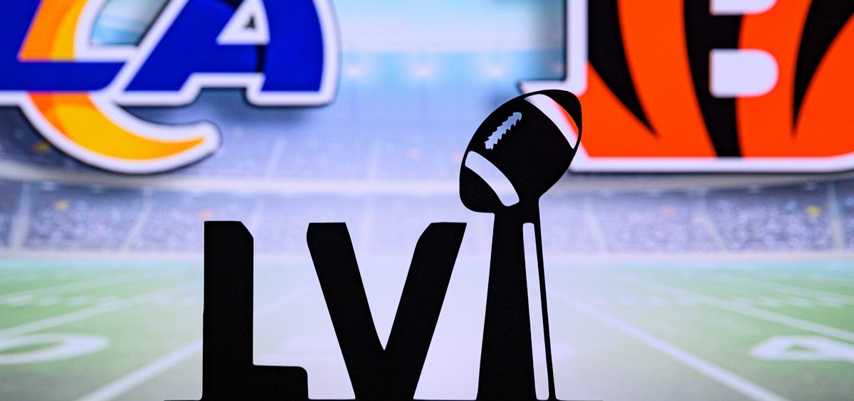 The Super Bowl LVI logo sit in front of a screen that has the Rams logo on the left and the Bengals logo on the right