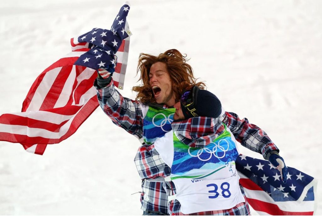 White celebrates with a teammate after he won the gold medal in the men's halfpipe final at the Vancouver 2010 Winter Olympics.
