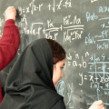 Iranian women working complex math on blackboard