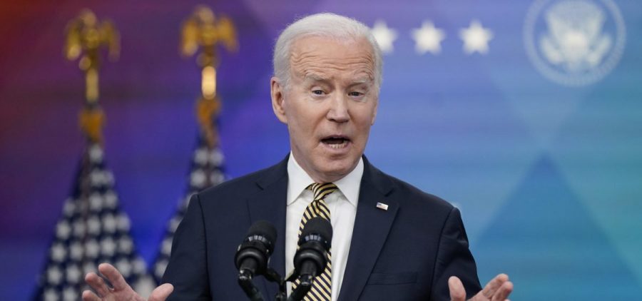 President Joe Biden speaks from a podium at a press conference