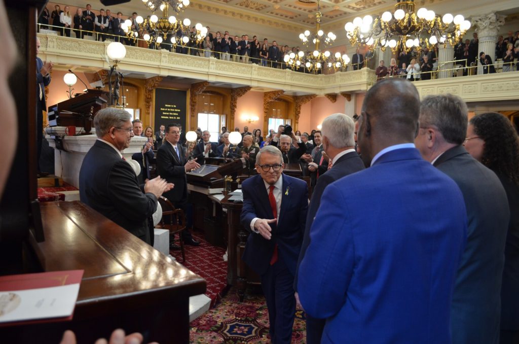 Gov. Mike DeWine (R-Ohio) greets members of his administration in the Ohio House chamber.