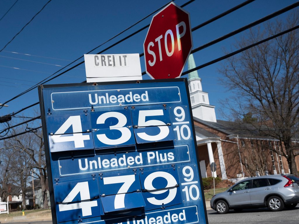 A car passes a gas station sign in Annapolis, Md., on March 14 as record high gas prices hit working class Americans.
