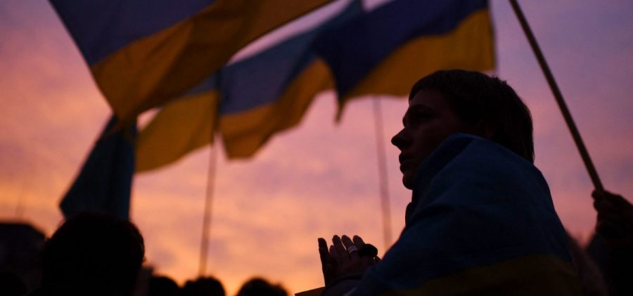 A demonstrator, holding a Ukrainian flag, participates in a demonstration called by 70 associations in support of Ukraine on the square of Paris' town hall on Thursday.