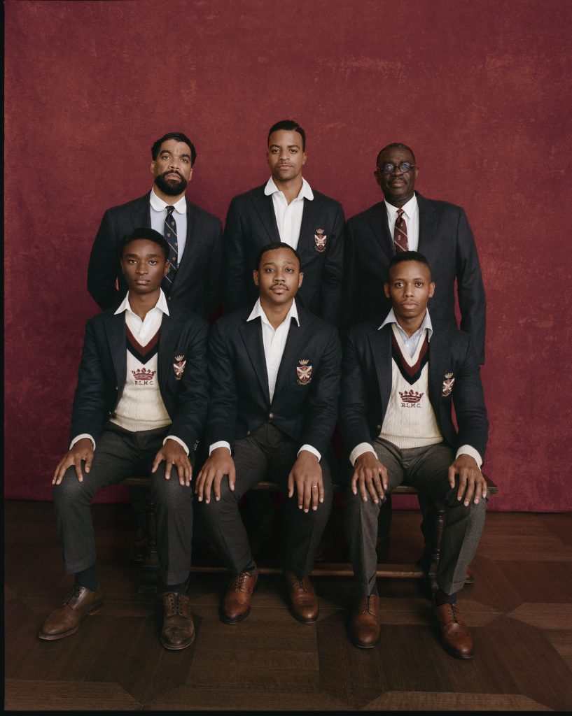 Three Black men stand in front of three Black men sitting for a portrait while wearing clothing from the new Ralph Lauren line