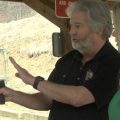 Jim Salzman, Board Member of Hilltop Gun Club, shows WOUB Reporter Lexi Lepof how to safely handle a concealed carry weapon.
