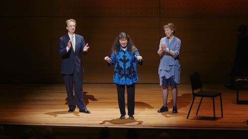 Three artistic directors on stage welcoming an audience back