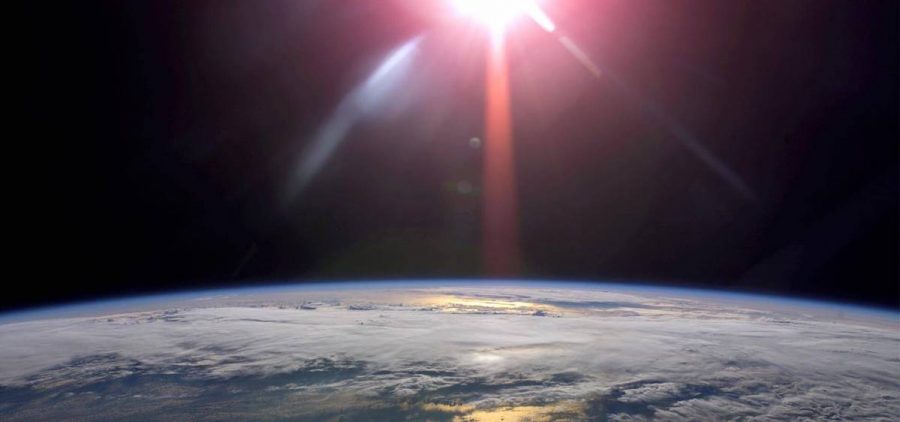 image from space with sun light shining on earth