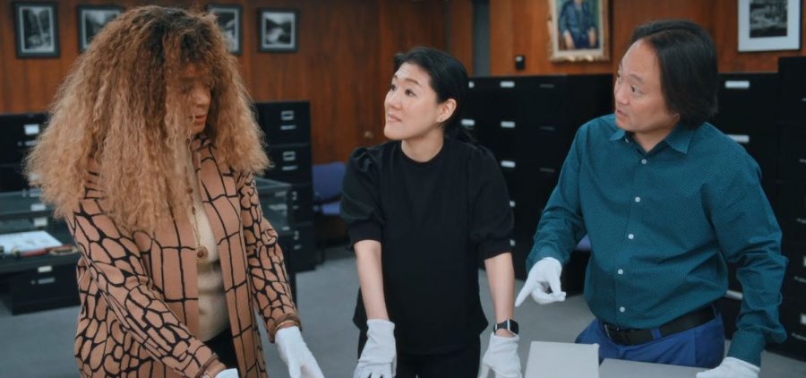 three archivists with gloves on observing Florence Price’s sheet music.