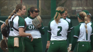 Ohio pitcher Mackensie Kohl (second from left) chats with her team in the Bobcats' game with Akron on April 5, 2022.