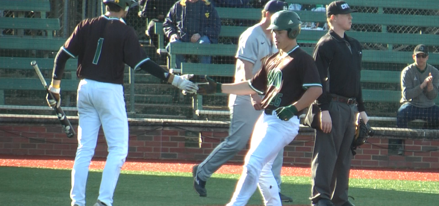 Ohio's Will Sturek (26) gives a high-five to Nick Dolan (1) after Sturek scores a run in the seventh inning of OU's game against Toledo on April 10, 2022.
