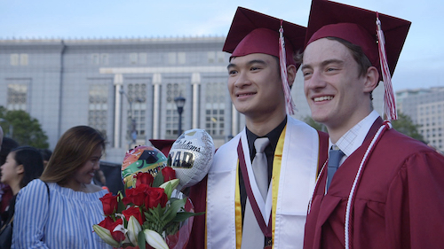 Two high school students at graduation