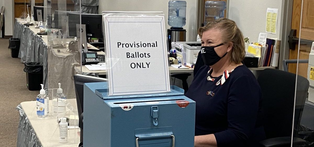 A Delaware County Board of Election worker sits at desk to check voters in during the November 2020 election