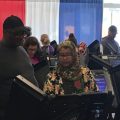 A Franklin County poll worker sets up a machine for an early in-person voter at the county's Early Vote Center