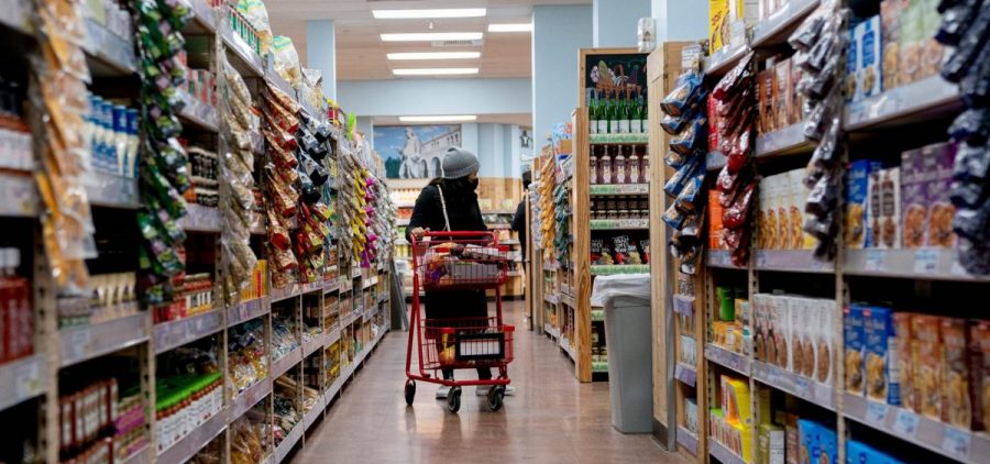 A shopper walks through a grocery store in Washington, D.C