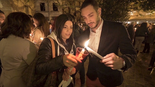 Couple lighting candle together on Easter