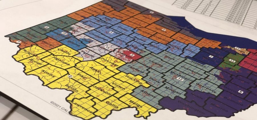 Commissioners hand out different maps to be submitted during a Ohio Redistricting Commission meeting on March 2, 2022.
