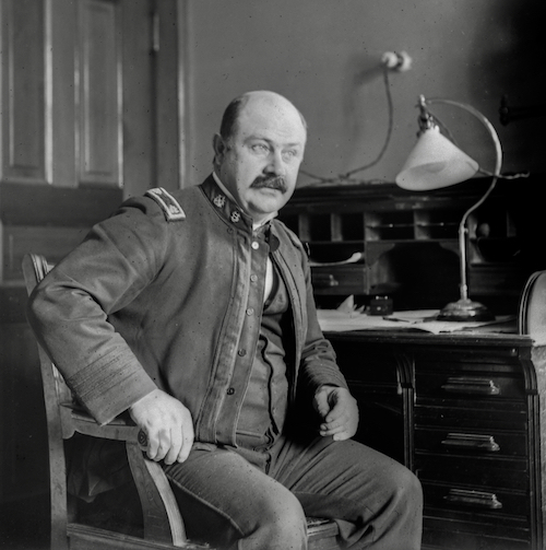 Dr. Joseph J. Kinyoun, 1901 sitting in chair by desk
