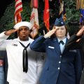 four branches of military saaluting during Memorial Day concert