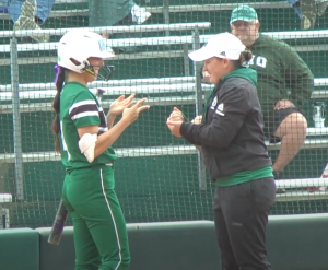 Fifth year outfielder Allie Englant (4) plays rock-paper-scissors with first base coach Ashley Taylor at home plate before her at bat in the 1st inning of OU's game against Western Michigan on May, 8 2022 