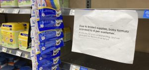 A sign telling consumers of limits on the purchase of baby formula hangs on the edge of an empty shelf for the product in a King Soopers grocery store, Wednesday, in Denver.