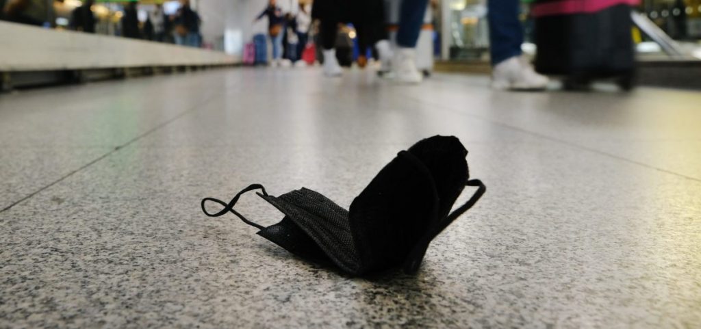 A mask lies on the ground at John F. Kennedy International Airport