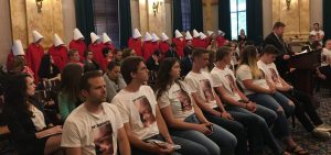 Abortion opponents (front row) and abortion rights supporters (dressed as handmaids in back) listen to testimony on an abortion bill in a committee at the Ohio Legislature