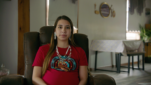 native american teen girl sitting in living room
