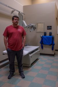 Brandon Crum stands in a patient screening room. 
