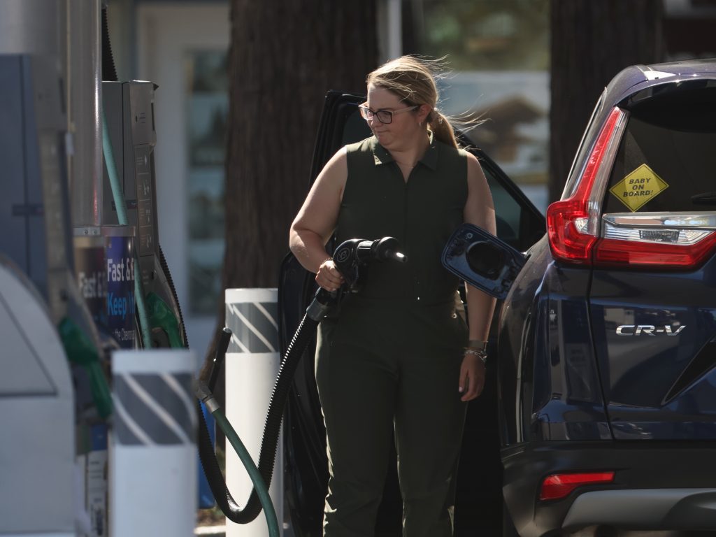 A customer prepares to pump gas into her car at a gas station in San Rafael, Calif., on May 20.